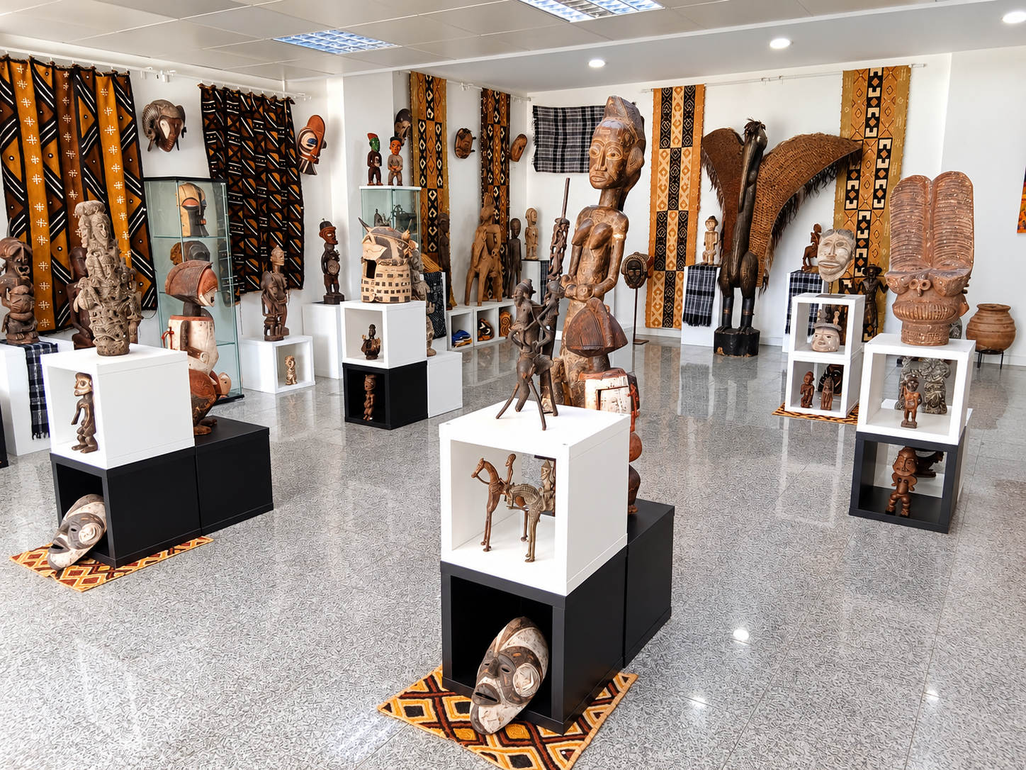Interior of Afrika Infinity African ethnographic art gallery in Lisbon, featuring traditional sculptures, masks, bronzes and African textiles.