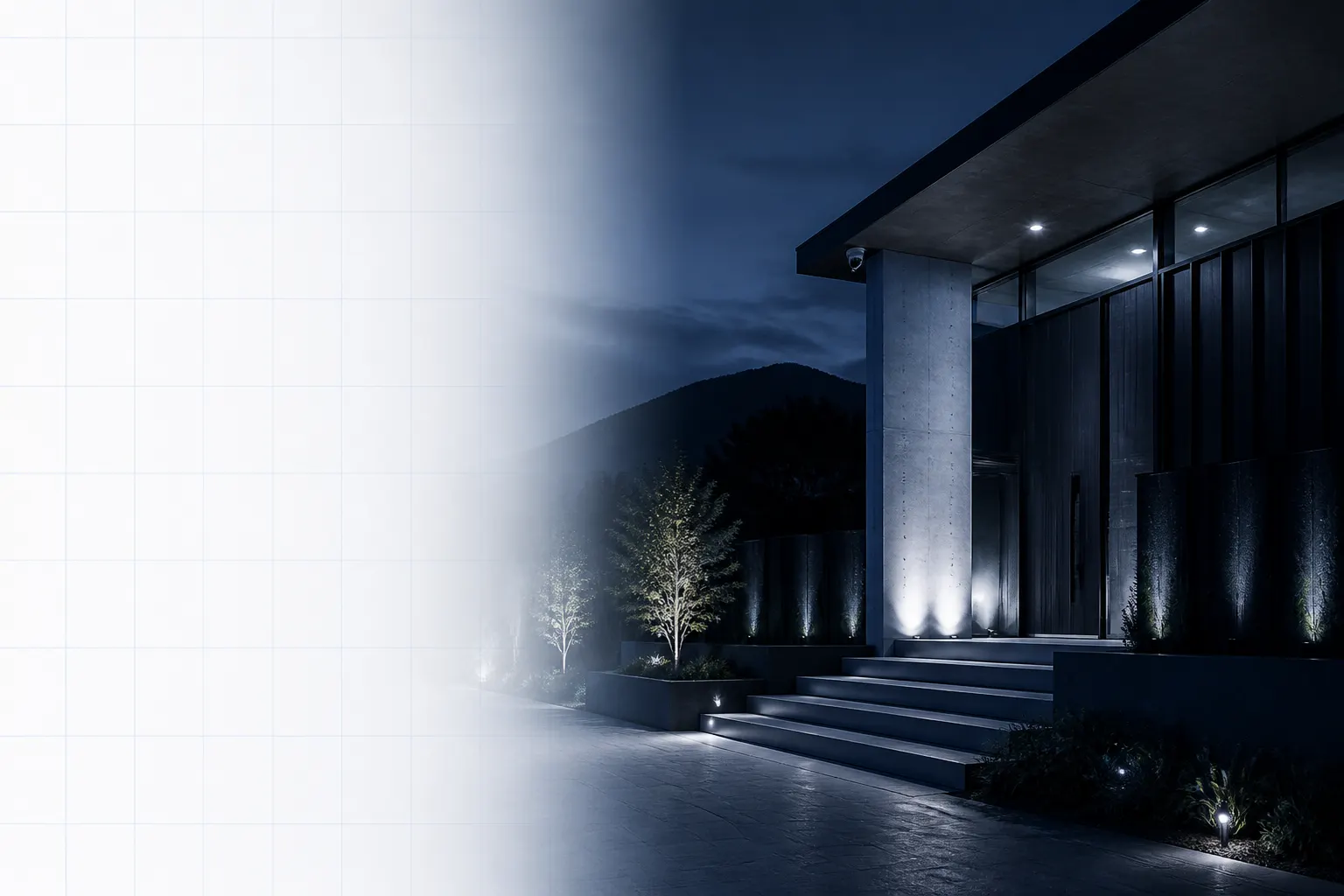 Acceso residencial contemporáneo iluminado de noche con una cámara de seguridad instalada bajo el alero.