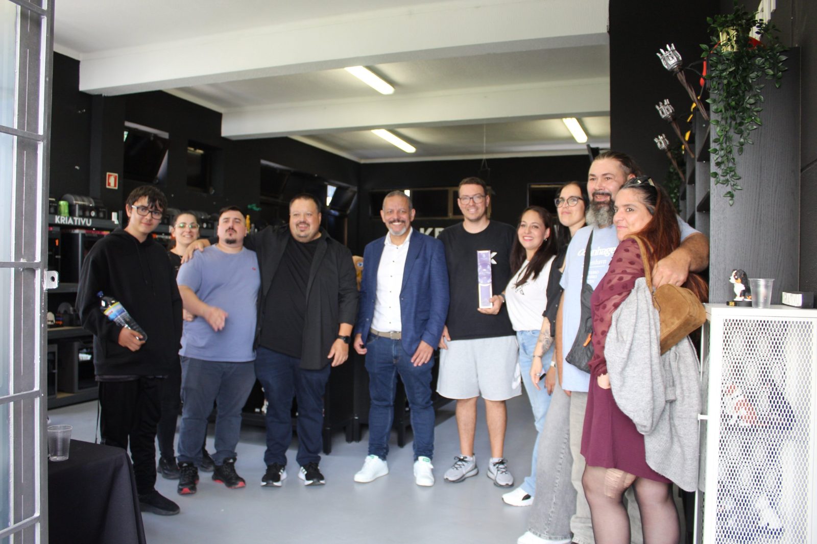 Convidados no interior da loja Kriativu3D, com as impressoras 3D ao fundo