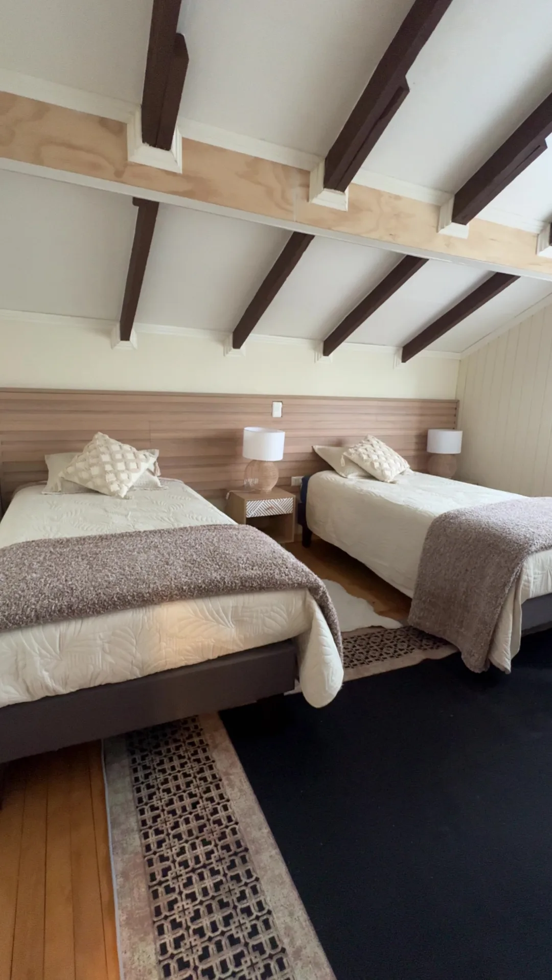 Dormitorio de la Casona con dos camas y vigas a la vista, con luz de día