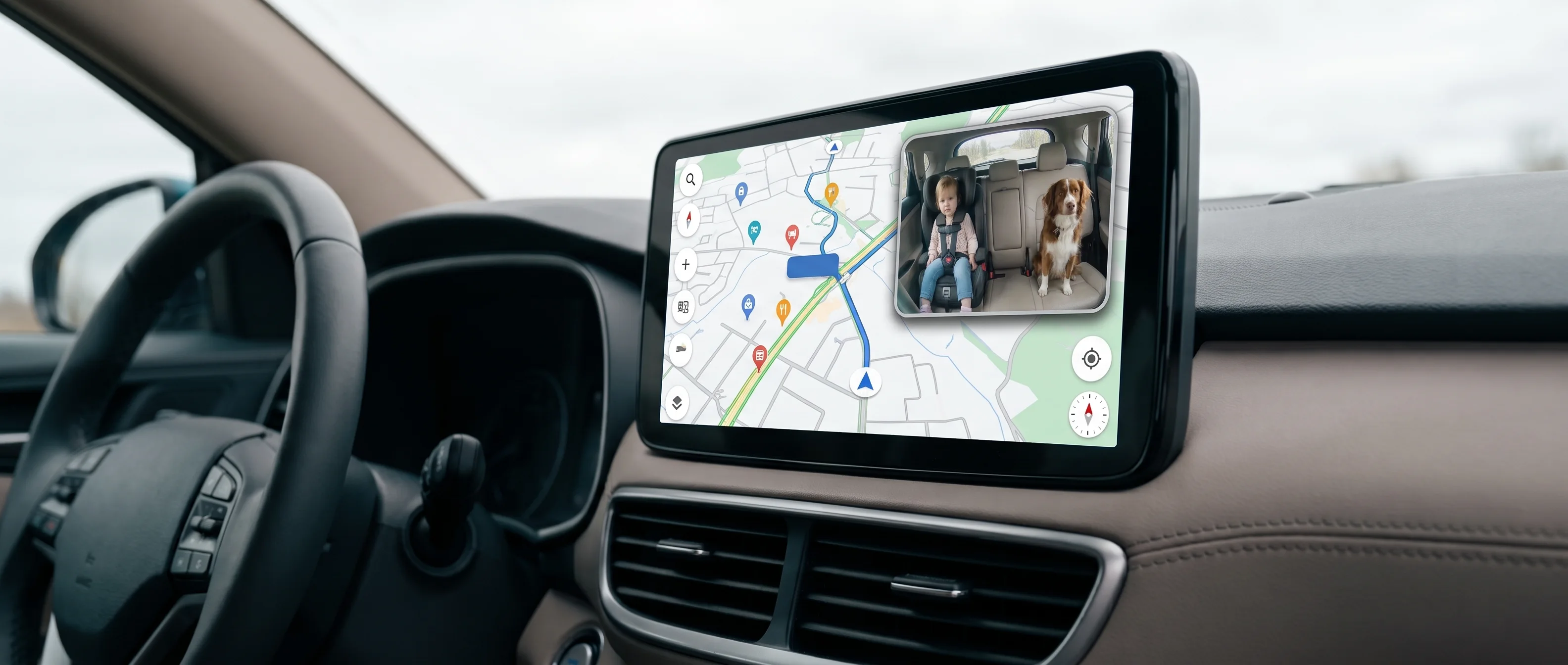 Pantalla del auto con el mapa a pantalla completa y un recuadro con la vista de la cámara del asiento trasero